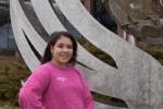 student wearing BHC 东校区 shirt stands in front of a sculpture