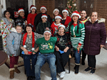 people wearing Christmas hats and smiling